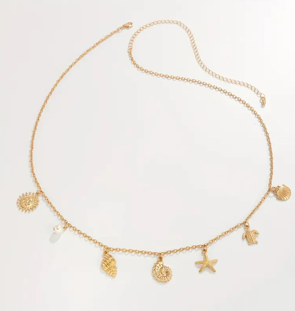 A delicate golden waist chain adorned with seashells, a starfish, and ocean-inspired charms. Designed to capture the essence of summer, it adds a playful yet elegant touch to your swimwear or beachside outfits.