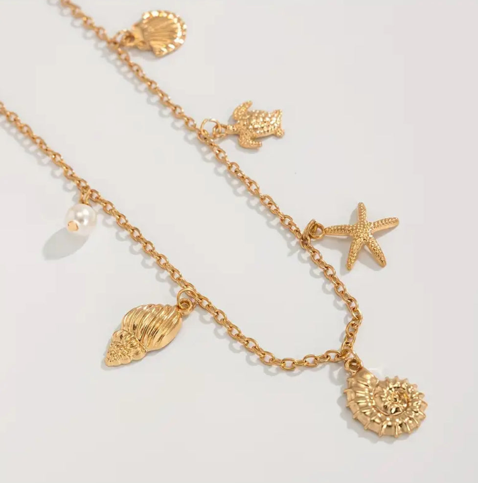 A delicate golden waist chain adorned with seashells, a starfish, and ocean-inspired charms. Designed to capture the essence of summer, it adds a playful yet elegant touch to your swimwear or beachside outfits.